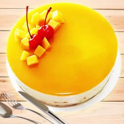 Scrumptious Eggless Mango Cake with Cherry N Mango Topping to Cooch Behar