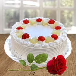 Attractive mouth watering Pineapple Cake with a Red Rose to Kanjikode