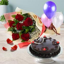 Appealing Gift of Truffle Cake with Red Roses Bunch and Balloons to Muvattupuzha