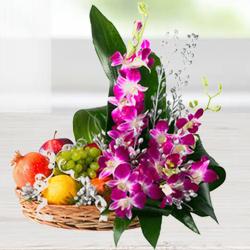 Mouth-watering assorted Fruit basket with charming Flowers  to Kanjikode