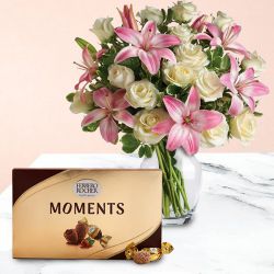 Delicate Lilies n Roses in Glass Vase with Ferrero Rocher Moments to Sivaganga