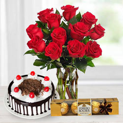 Stunning Bouquet of Red Roses with Ferrero Rocher and Black Forest Cake to Kanjikode