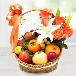Decorative Imported Fruits Basket with Orange Roses n White Lily to Marmagao