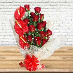Amusing Red Roses N Anthurium Bouquet Wrapped in Tissue to Muvattupuzha