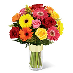Multi-Hued Flowers arranged in a Glass Vase to Marmagao