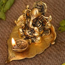 Marvelous Ganesha on Leaf with Diya to Dadra and Nagar Haveli